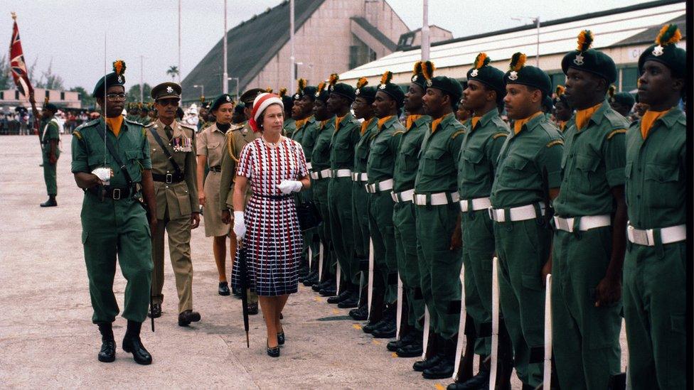 Queen Elizabeth ll inspects a guard of honour as she arrives in Barbados on October 31, 1977