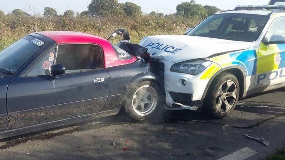 Police car crashes into back of stationary car