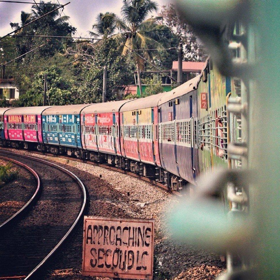 A train with brightly coloured coaches.