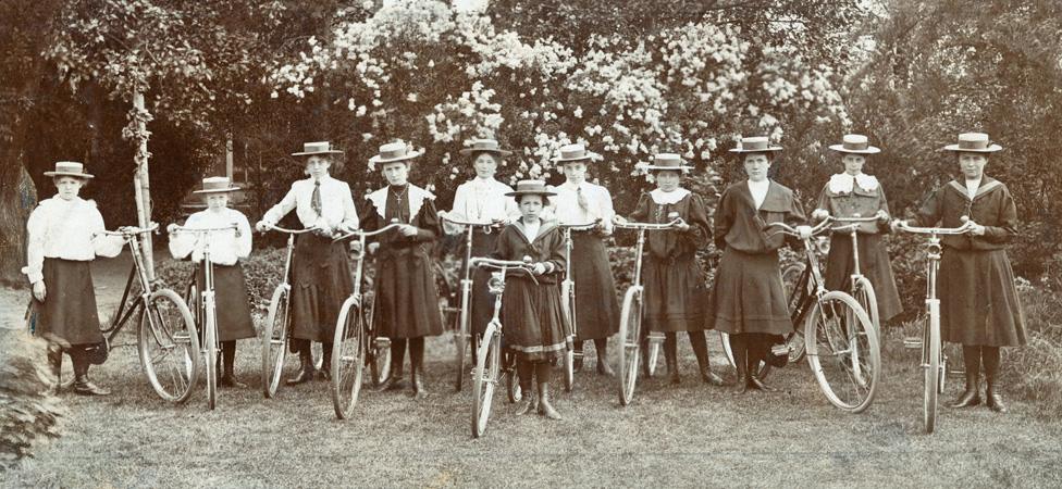 A group of women and girls with bikes, circa 1900