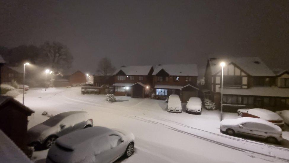 Snow covered street and cars