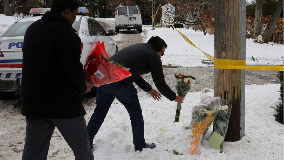 Mourners place flowers outside the home of billionaire founder of Canadian pharmaceutical firm Apotex Inc., Barry Sherman and his wife Honey, who were found dead under circumstances that police described as "suspicious", in Toronto, Ontario, Canada, December 17, 2017