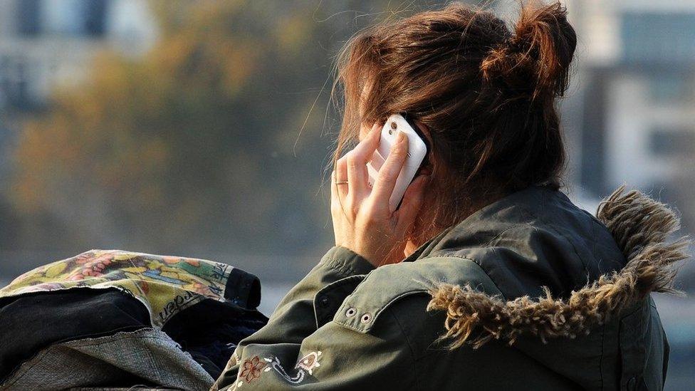 A generic stock photo of a woman using a mobile phone