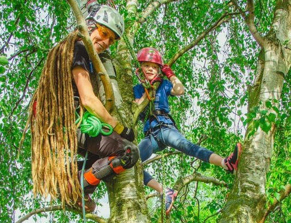 Jessica and her daughter Willow posing high up in a tree