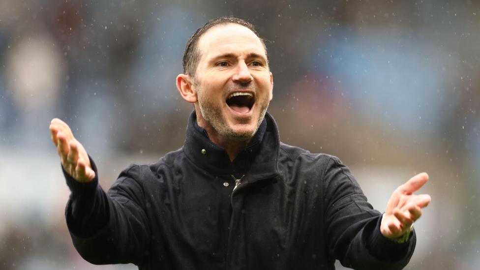 Frank Lampard celebrating a victory with arms out raised.