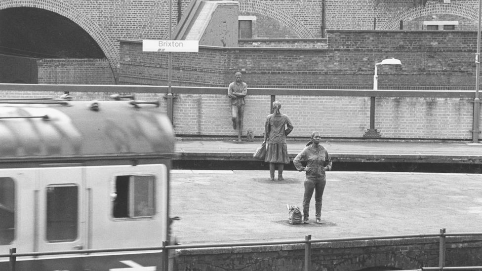 The 'Platforms Piece' statues at Brixton station in the 1980s - black and white image