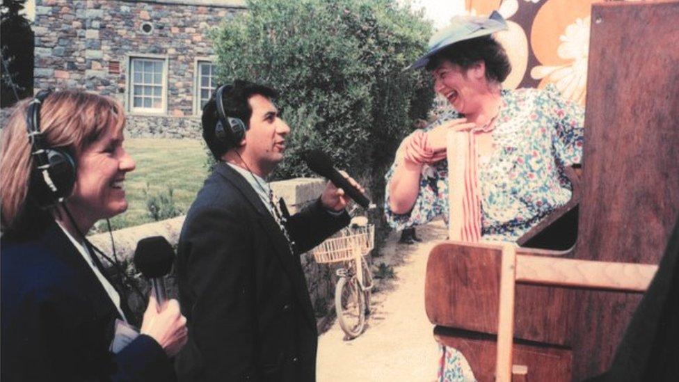 Kay Langlois and Murrary Norton interviewing a woman on a road in Sark