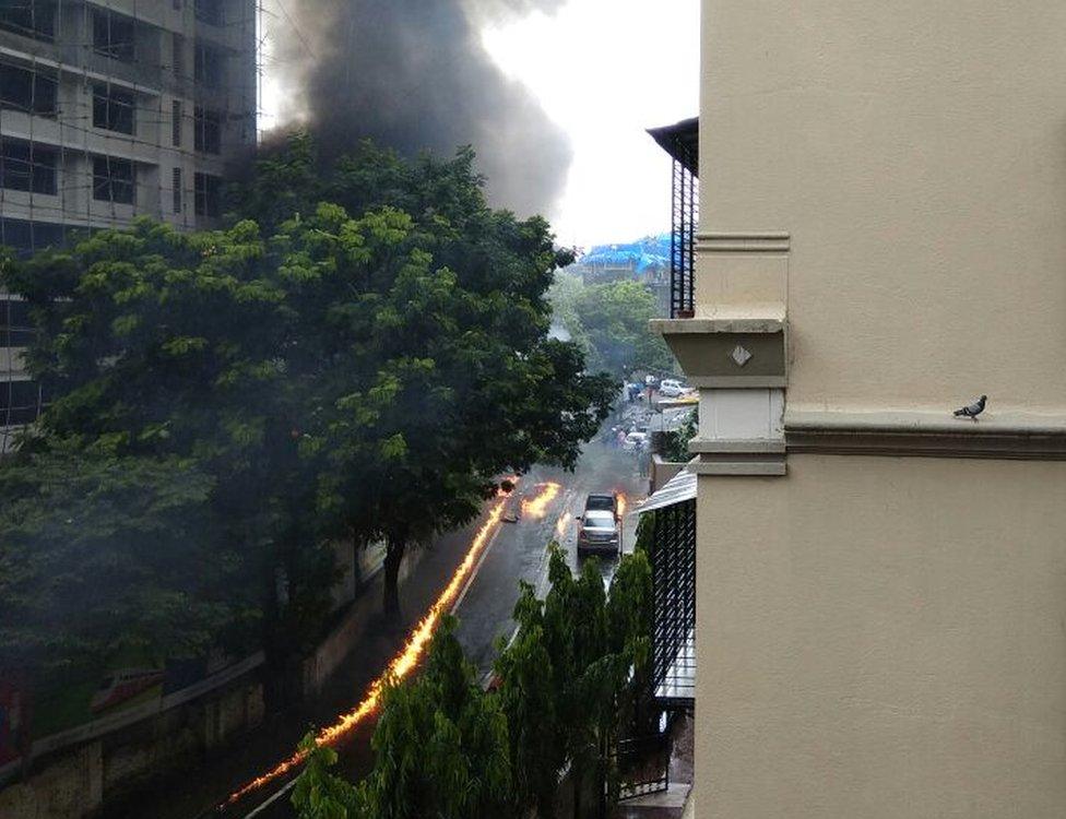 Smoke rises up from where the plane crashed and burst into flames.