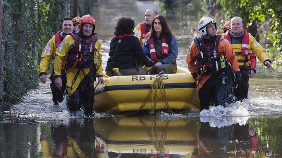 Fire and rescue crews rescue residents whose houses have been flooded in Staines-upon-Thames