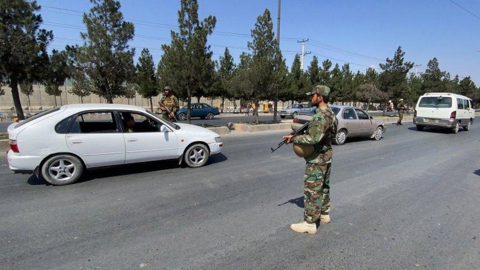 A member of the Taliban stands guard at a checkpoint in Kabul