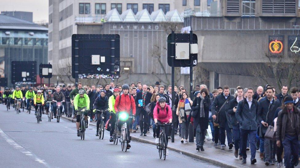 Crowded pavements at Waterloo Bridge as commuters walk to work