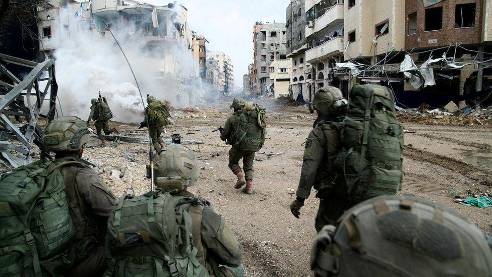 Handout image from the Israel Defense Forces (IDF) showing Israeli soldiers operating inside the Gaza Strip (18 December 2023)