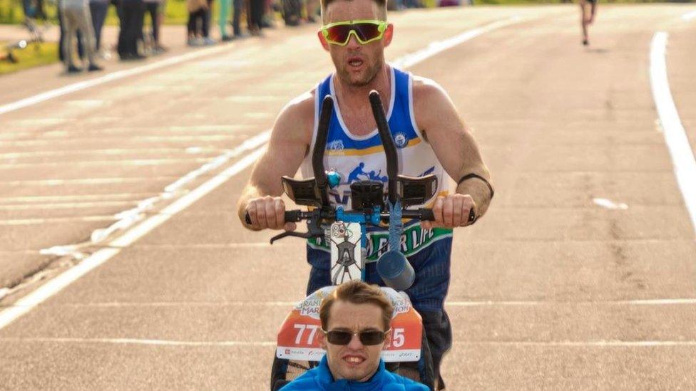 Sean McQuaid pushed his teammate Riley Pathman in a specially-adapted chair