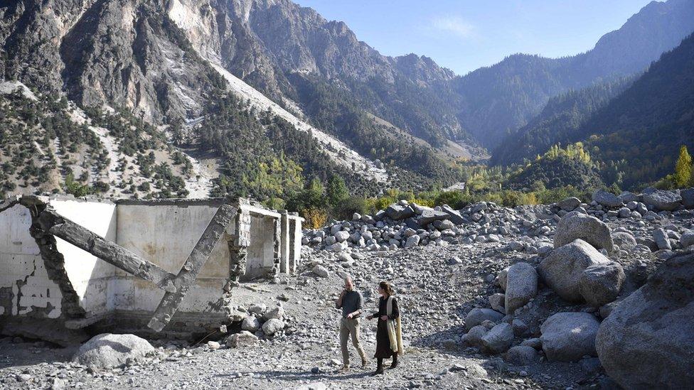 The Duke and Duchess of Cambridge walk amongst flood-damaged ruins in the village of Bumburet