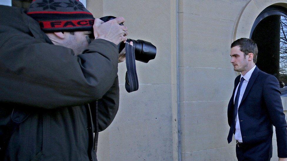 A photographer takes Adam Johnson's picture as he arrives at Bradford Crown Court