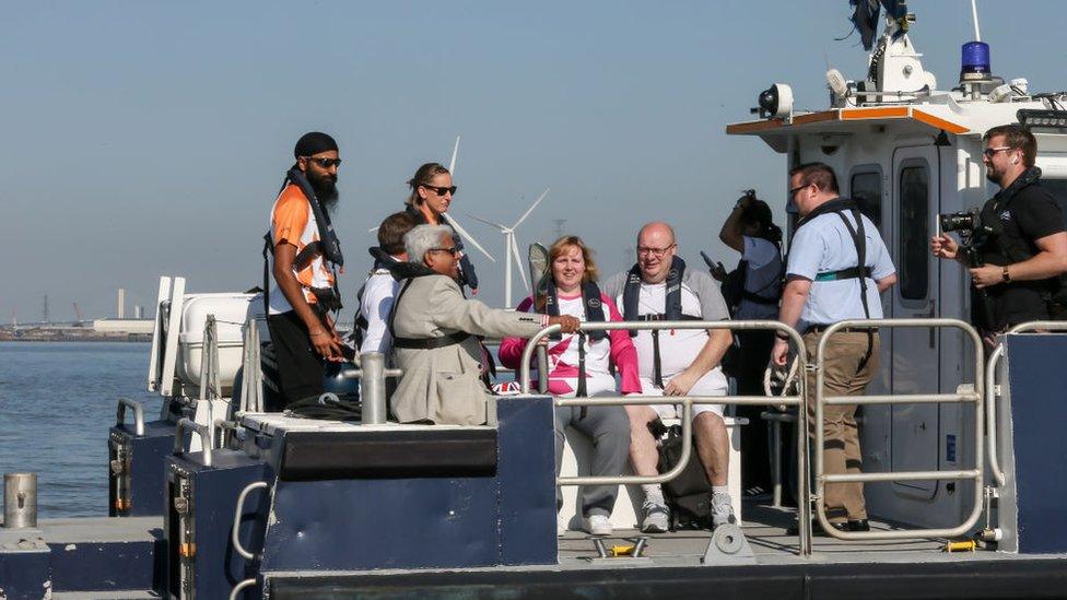 Baton bearer Joanne Rout holds the Queen's Baton during the Birmingham 2022 Queen's Baton Relay on a boat between Gravesend and Tilbury