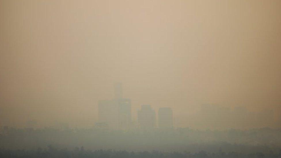 Buildings are seen through the air pollution during a day where Mexico City's authorities have activated a contingency plan due to bad air conditions on May 14, 2019 in Mexico City