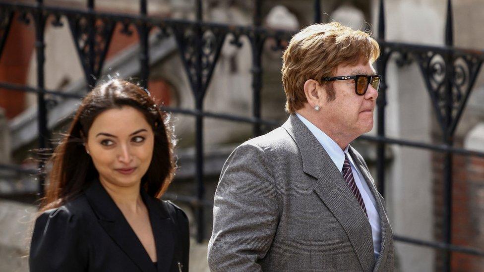 Sir Elton John wearing sunglasses on his way into the High Court on Monday