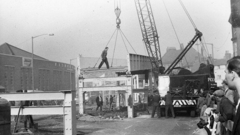 A man walks across scaffolding