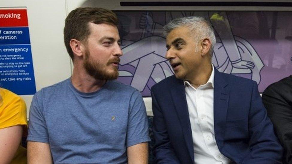 London Mayor Sadiq Khan (2nd-R) speaks to fellow passengers in the first Night Tube train along the Victoria line on August 20, 2016 in London, England