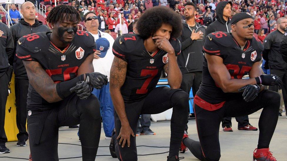 Eli Harold, Colin Kaepernick and Eric Reid kneeling before a match in 2016