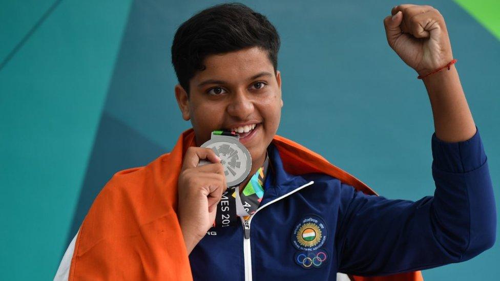 India's Shardul Vihan poses with his silver medal at the awards ceremony following the men's shooting double trap final at the 2018 Asian Games in Palembang on August 23, 2018.