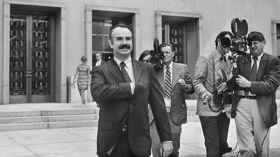 Former White House aide G Gordon Liddy is filmed by journalists as he leaves US District Court, where he pleaded Not Guilty of breaking into Democratic National Headquarters at the Watergate Hotel