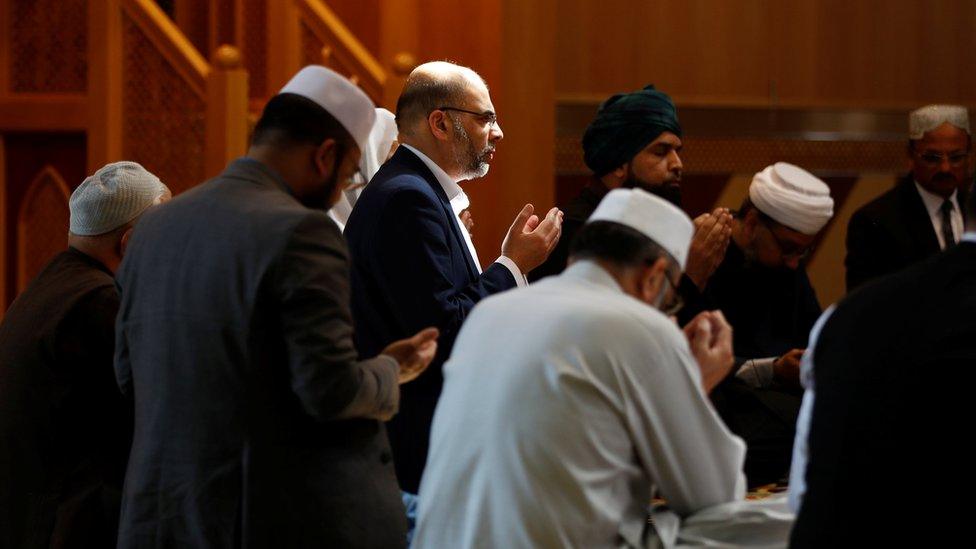 Muslim men pray for victims of the attack at Manchester Arena at a mosque in Manchester, Britain