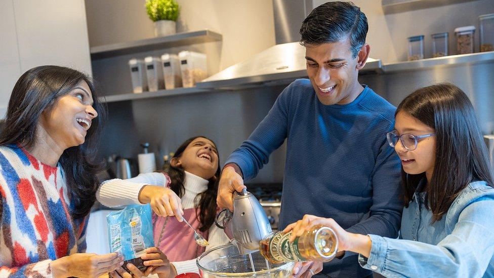 Rishi Sunak makes a cake with his two children and wife in a picture used for his official Christmas card