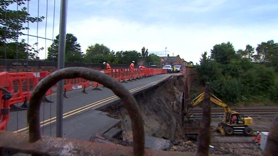 Collapsed bridge rubble on rail line