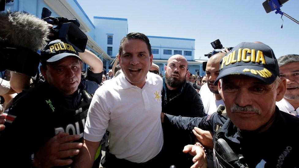 Fabricio Alvarado Muñoz, escorted away by police after casting his vote in February