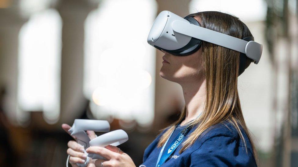 A woman wears an Oculus headset