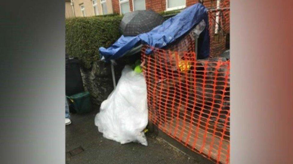 The shelter built to shield Geraint John Morris, including a tarpaulin and umbrella