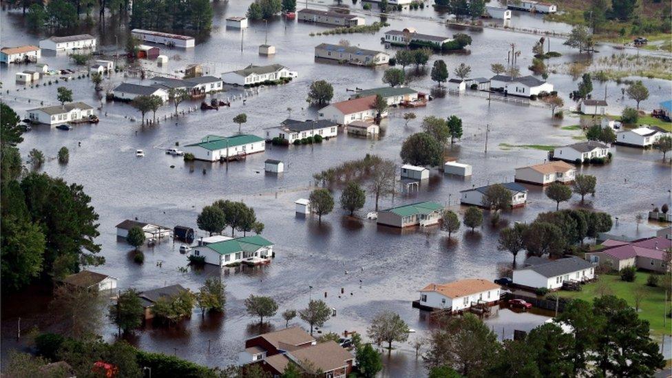 Homes sit in floodwater