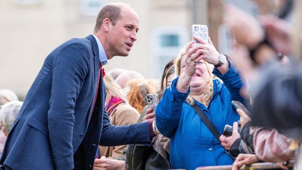 The Prince of Wales with a member of the public as he arrives for a visit to The Street, in Scarborough