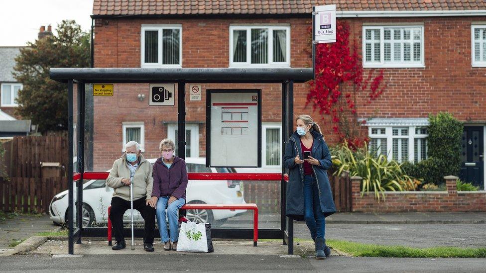 People waiting at bus stop