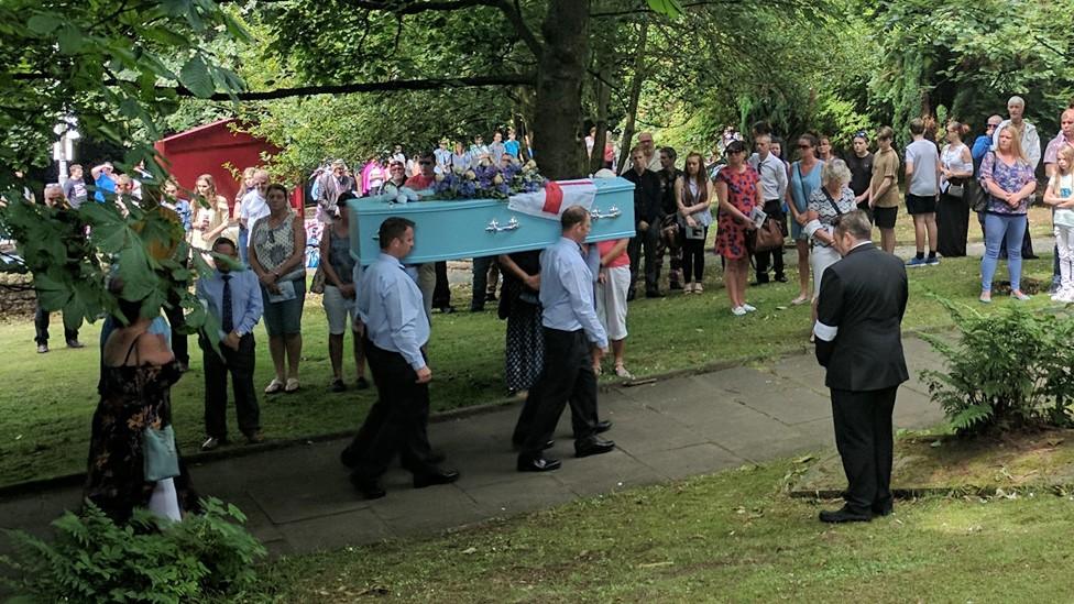 coffin going into the church