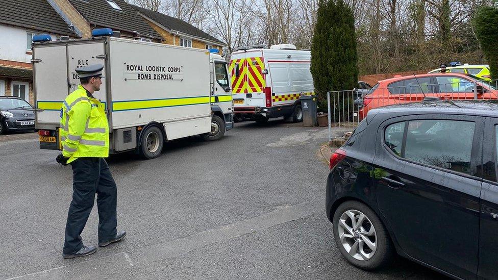 A bomb disposal unit van and police vehicles