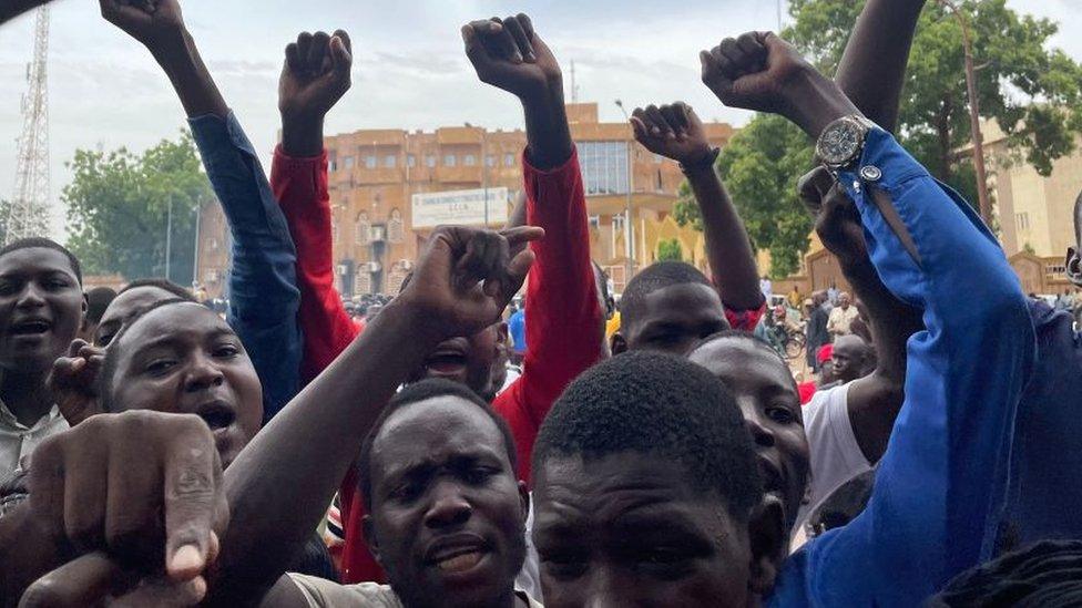 Supporters of the Nigerien defence and security forces gather during a demonstration outside the national assembly in Niamey