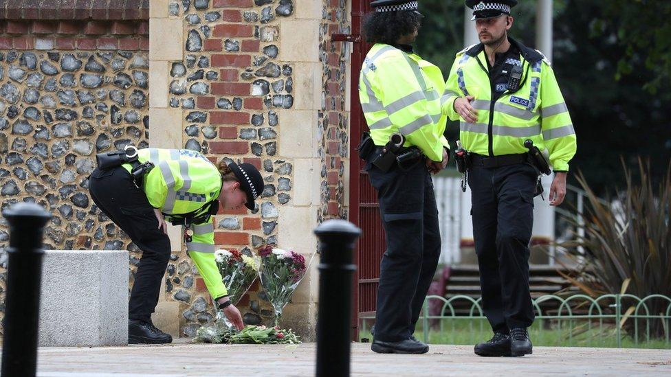 Police move flowers from Abbey Gate closer to the entrance at Forbury Garden