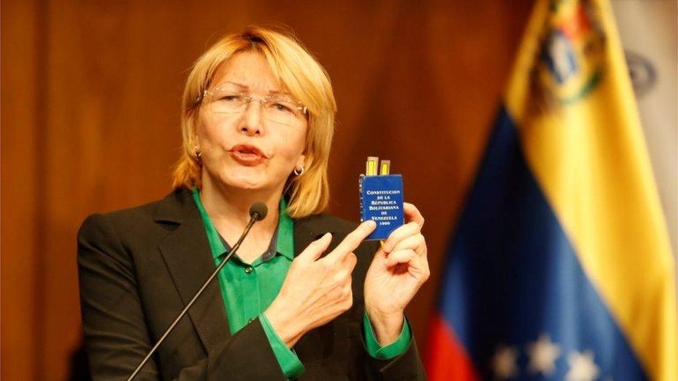 Venezuela's chief prosecutor Luisa Ortega Diaz holds a Venezuelan constitution during a news conference in Caracas, Venezuela, July 25, 201