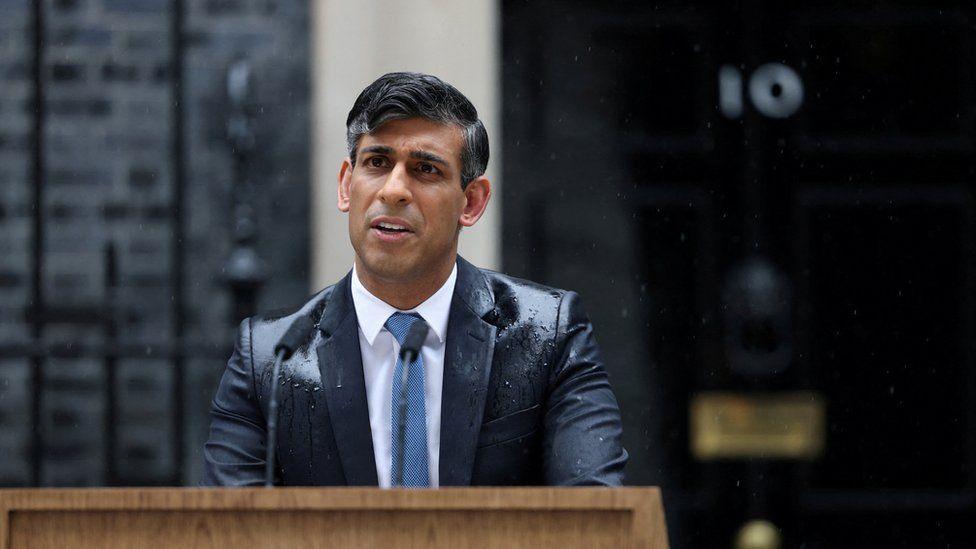 Rishi Sunak getting soaked in the rain at a pedestal in Downing Street as he announced a general election would take place on 4 July