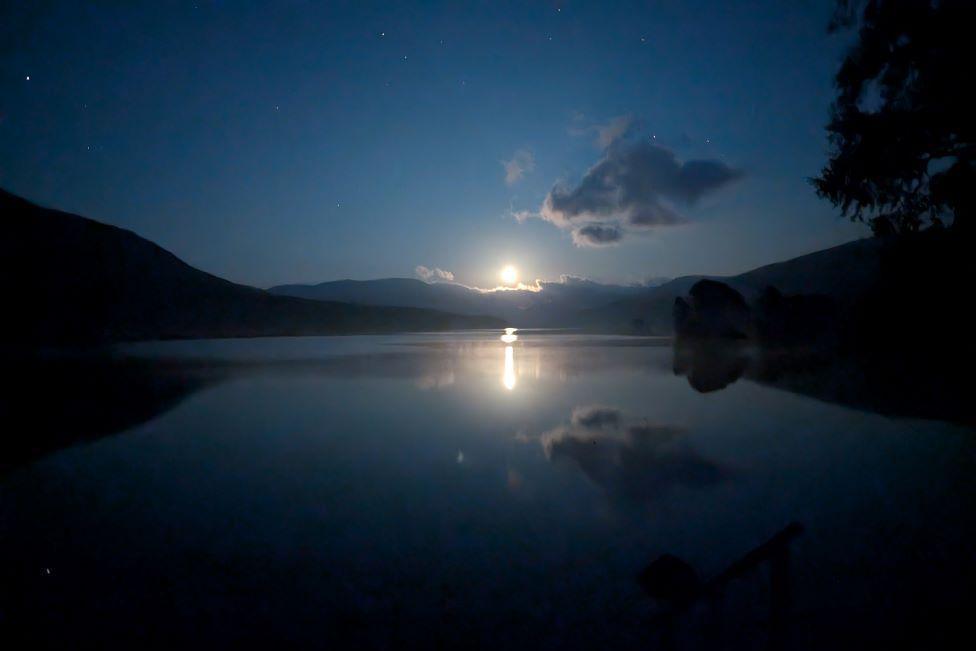 Moon at night, reflected in water