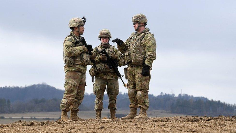 US soldiers stand together prior to an artillery live fire event at the military training area in Grafenwoehr