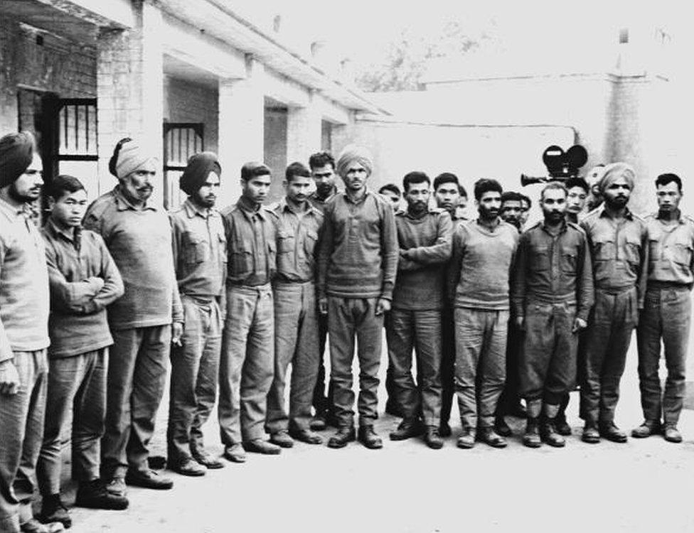 A group of Indian soldiers captured by Pakistani army pose for a photographer in a POW camp in December 1971 during the India-Pakistan border conflict