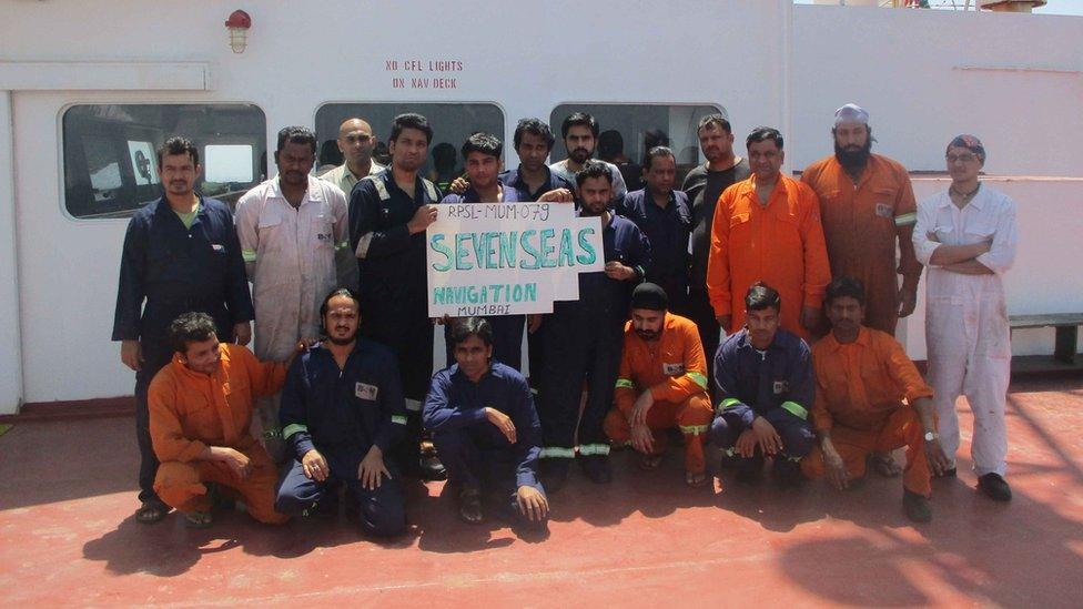 Picture of crew holding a sign