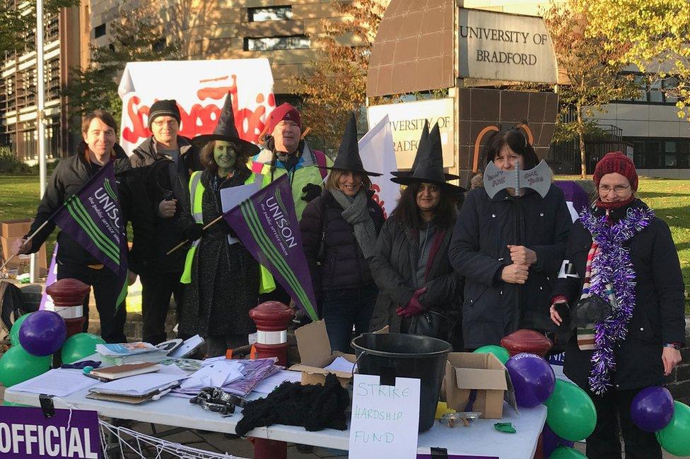 People dressed in Halloween costumes on a picket line