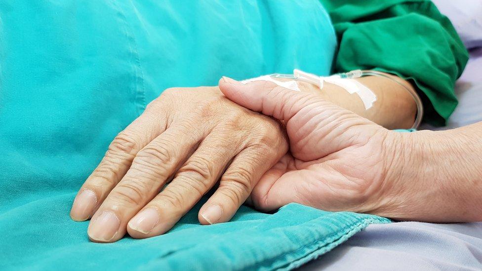 Doctor holding patient's hand