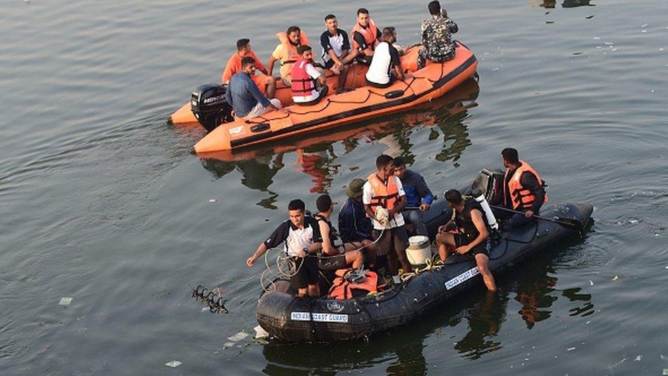 Rescuers search after a bridge across the river Machchhu collapsed at Morbi in India's Gujarat state on October 31, 2022