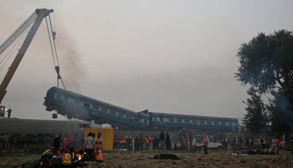 Rescuers work at the site after 14 coaches of an overnight passenger train rolled off the track near Pukhrayan village in Kanpur Dehat district of the northern Indian state of Uttar Pradesh, India, Monday, 21 November 2016